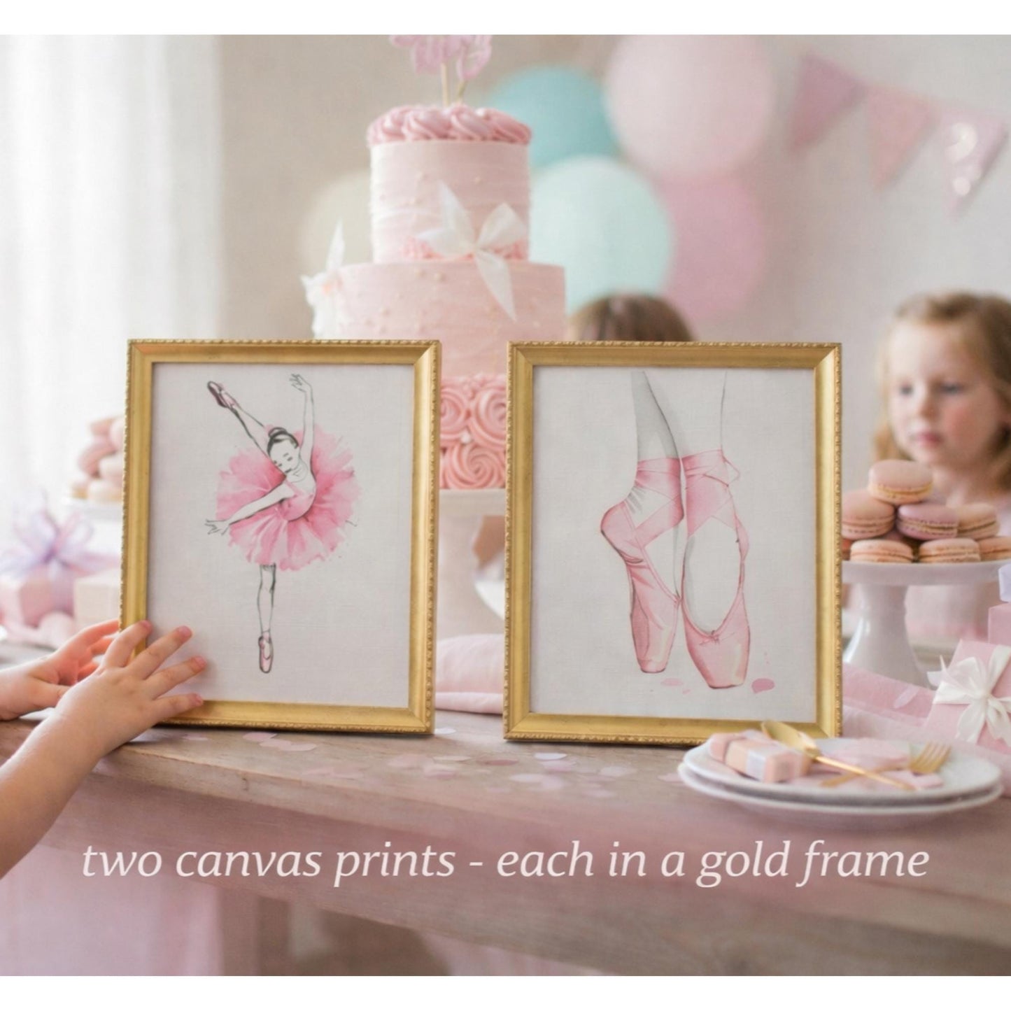 Two framed ballet-themed prints on a table with a cake and balloons in the background.