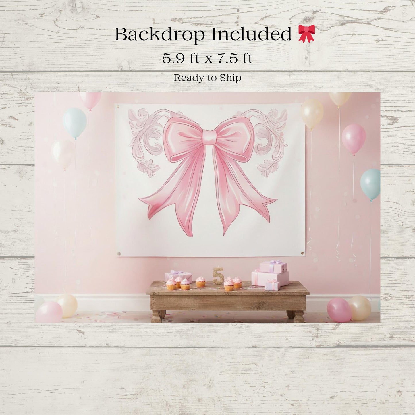 Pink bow-themed backdrop with balloons and decorative elements on a wooden floor.