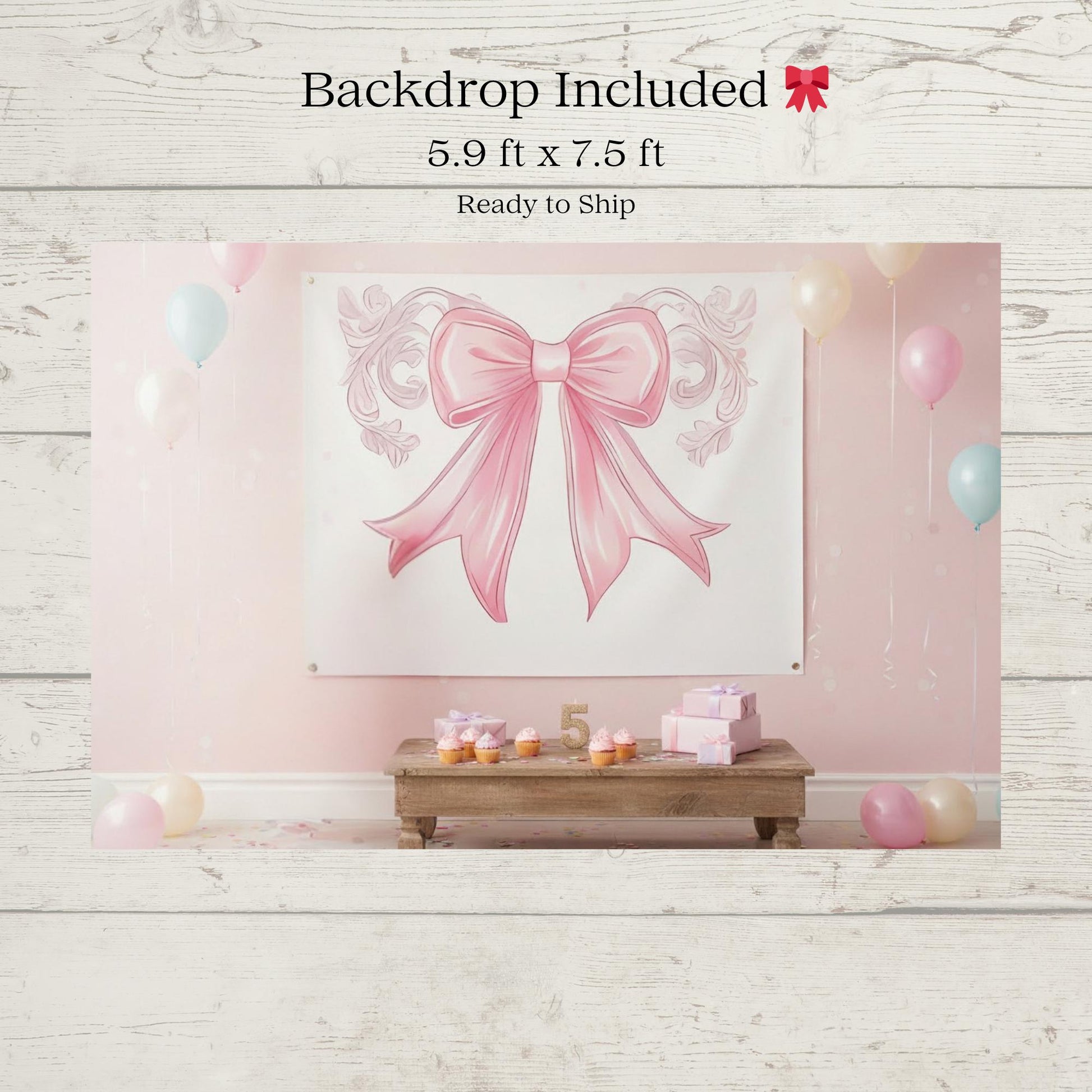 Pink bow-themed backdrop with balloons and decorative elements on a wooden floor.