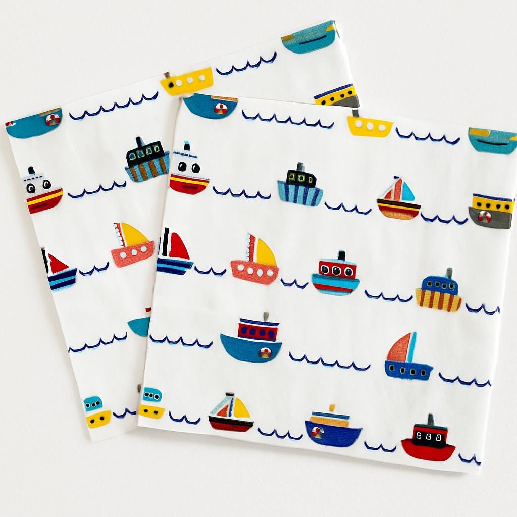 Two sheets of paper with colorful boat pattern on a white background