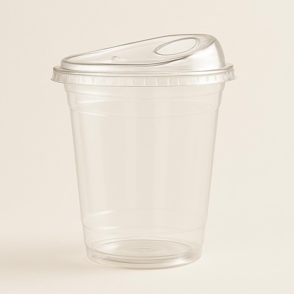 Clear plastic cup with a lid on a beige background